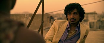 Movie still from “Extraction” (2020), directed by Sam Hargrave – A person wearing a jacket; Close Up shot, Over the shoulder angle