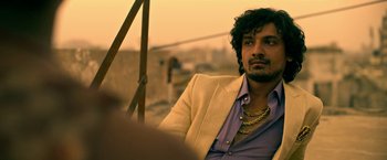 Movie still from “Extraction” (2020), directed by Sam Hargrave – A person wearing a jacket; Close Up shot, Low angle