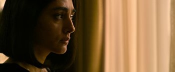 Movie still from “Extraction” (2020), directed by Sam Hargrave – A person looking at something; Close Up shot, Over the shoulder angle