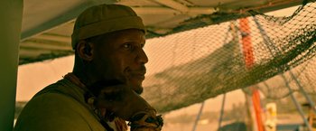 Movie still from “Extraction” (2020), directed by Sam Hargrave – A person wearing a hat; Close Up shot, Low angle