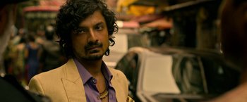 Movie still from “Extraction” (2020), directed by Sam Hargrave – A person wearing a jacket; Close Up shot, Over the shoulder angle