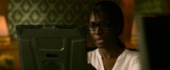 Movie still from “Extraction” (2020), directed by Sam Hargrave – A woman wearing glasses looking at a computer screen; Close Up shot, Over the shoulder angle