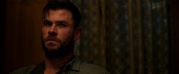 Movie still from “Extraction” (2020), directed by Sam Hargrave – A person with a beard; Close Up shot, Low angle