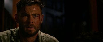 Movie still from “Extraction” (2020), directed by Sam Hargrave – A person wearing a shirt; Close Up shot, Over the shoulder angle