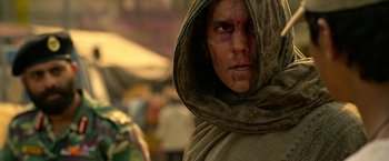 Movie still from “Extraction” (2020), directed by Sam Hargrave – A man with a hood and a face covered in dirt; Close Up shot, Low angle