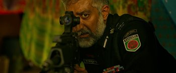 Movie still from “Extraction” (2020), directed by Sam Hargrave – A person with a gun; Close Up shot, Low angle