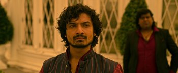 Movie still from “Extraction” (2020), directed by Sam Hargrave – A person wearing a vest; Close Up shot, Low angle