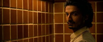 Movie still from “Extraction” (2020), directed by Sam Hargrave – A person in a room; Close Up shot, Low angle