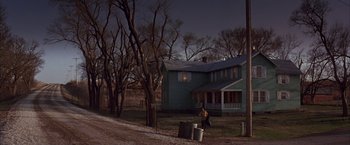 Movie still from “Mars Attacks!” (1996), directed by Tim Burton – A person walking in front of a house at night; Extreme Wide shot, Low angle