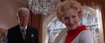 Movie still from “Mars Attacks!” (1996), directed by Tim Burton – A man and a woman standing in front of chandeliers; Close Up shot, Low angle