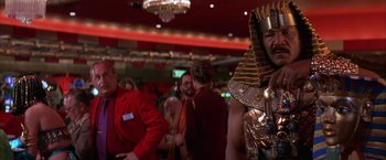 Movie still from “Mars Attacks!” (1996), directed by Tim Burton – A group of people standing in a room; Medium shot, Low angle