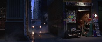 Movie still from “Mars Attacks!” (1996), directed by Tim Burton – A bus driving down a street in the dark; Wide shot, Low angle