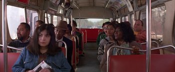 Movie still from “Mars Attacks!” (1996), directed by Tim Burton – A group of people riding on a bus; Medium shot, High angle