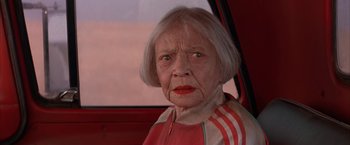 Movie still from “Mars Attacks!” (1996), directed by Tim Burton – An older woman sitting in the passenger seat of a car; Close Up shot, High angle