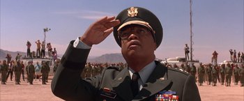 Movie still from “Mars Attacks!” (1996), directed by Tim Burton – A soldier saluting in front of a crowd of onlookers; Close Up shot, Low angle
