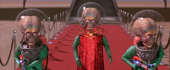Movie still from “Mars Attacks!” (1996), directed by Tim Burton – An image of an extraterrestrial in a red dress; Medium shot, Low angle