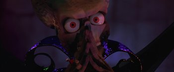 Movie still from “Mars Attacks!” (1996), directed by Tim Burton – The face of an evil looking creature; Close Up shot, Low angle