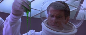 Movie still from “Mars Attacks!” (1996), directed by Tim Burton – A man in a spacesuit is holding a green object; Close Up shot, High angle