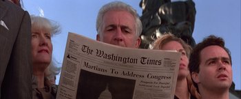 Movie still from “Mars Attacks!” (1996), directed by Tim Burton – A man reading a washington times newspaper; Close Up shot, Low angle
