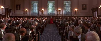 Movie still from “Mars Attacks!” (1996), directed by Tim Burton – A woman in a red dress standing in front of an audience; Extreme Wide shot, High angle
