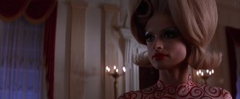 Movie still from “Mars Attacks!” (1996), directed by Tim Burton – A person with a candle in the background; Close Up shot, Low angle