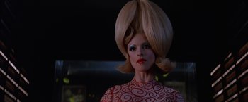 Movie still from “Mars Attacks!” (1996), directed by Tim Burton – A woman with a big hair style and a red dress; Close Up shot, Low angle