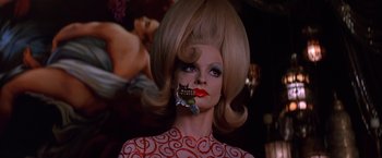 Movie still from “Mars Attacks!” (1996), directed by Tim Burton – A woman with blonde hair and a fake teeth; Close Up shot, Low angle