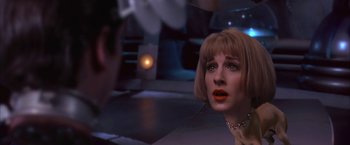 Movie still from “Mars Attacks!” (1996), directed by Tim Burton – A person wearing a dress; Close Up shot, Over the shoulder angle