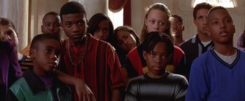 Movie still from “Mars Attacks!” (1996), directed by Tim Burton – A group of young people standing next to each other in a room; Close Up shot, High angle