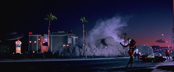 Movie still from “Mars Attacks!” (1996), directed by Tim Burton – A large amount of smoke billows out of a building; Extreme Wide shot, Low angle