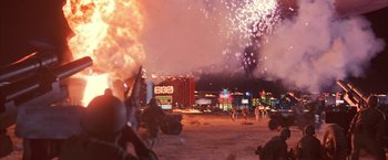Movie still from “Mars Attacks!” (1996), directed by Tim Burton – Fireworks explode in the sky over a city at night; Extreme Wide shot, Low angle