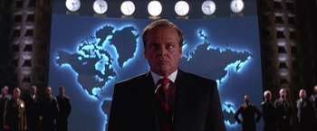 Movie still from “Mars Attacks!” (1996), directed by Tim Burton – A man in a suit and a red and white striped tie; Medium shot, Low angle