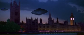 Movie still from “Mars Attacks!” (1996), directed by Tim Burton – An image of an alien flying over a city at night; Extreme Wide shot, Low angle