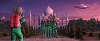 Movie still from “Mars Attacks!” (1996), directed by Tim Burton – A group of people standing next to each other in front of a building; Wide shot, Low angle