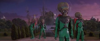 Movie still from “Mars Attacks!” (1996), directed by Tim Burton – A group of aliens are standing next to each other; Wide shot, Low angle