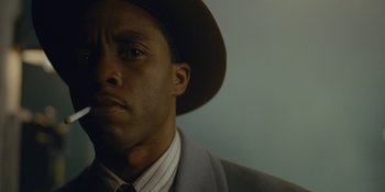 Movie still from “Marshall” (2017), directed by Reginald Hudlin – A person wearing a suit and a hat; Close Up shot, Low angle