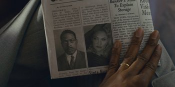 Movie still from “Marshall” (2017), directed by Reginald Hudlin – A person holding a newspaper with a picture of a man and a woman in it; Extreme Close Up shot, Overhead angle