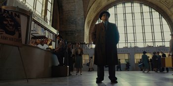 Movie still from “Marshall” (2017), directed by Reginald Hudlin – A man standing in front of a window in a train station; Wide shot, Low angle