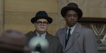 Movie still from “Marshall” (2017), directed by Reginald Hudlin – A couple of men standing next to each other wearing hats; Medium shot, Low angle