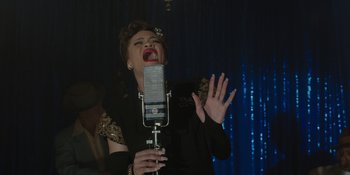 Movie still from “Marshall” (2017), directed by Reginald Hudlin – A woman singing into an old fashioned microphone; Close Up shot, High angle