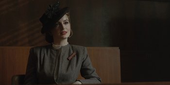 Movie still from “Marshall” (2017), directed by Reginald Hudlin – A woman wearing a hat sitting at a wooden table; Close Up shot, Over the shoulder angle