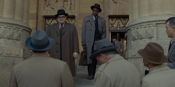 Movie still from “Marshall” (2017), directed by Reginald Hudlin – A group of men wearing hats and coats on steps; Wide shot, Low angle