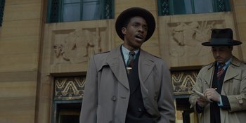 Movie still from “Marshall” (2017), directed by Reginald Hudlin – A man wearing a hat and a suit and tie; Medium shot, Low angle