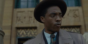 Movie still from “Marshall” (2017), directed by Reginald Hudlin – A man wearing a hat and a tie; Close Up shot, Low angle