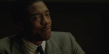 Movie still from “Marshall” (2017), directed by Reginald Hudlin – A person wearing a suit and tie; Close Up shot, Over the shoulder angle