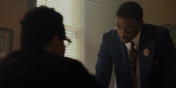 Movie still from “Marshall” (2017), directed by Reginald Hudlin – A man in a suit and tie talking to a woman; Close Up shot, Over the shoulder angle