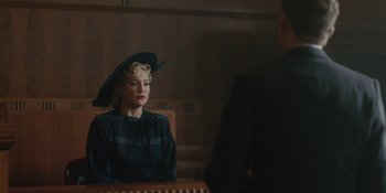 Movie still from “Marshall” (2017), directed by Reginald Hudlin – A woman with a hat sitting next to a man in a courtroom; Medium shot, Over the shoulder angle