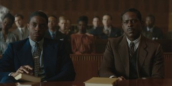 Movie still from “Marshall” (2017), directed by Reginald Hudlin – A group of people sitting in a court room; Medium shot, Low angle