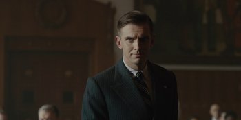Movie still from “Marshall” (2017), directed by Reginald Hudlin – A man wearing a suit and tie standing in a room; Close Up shot, Low angle