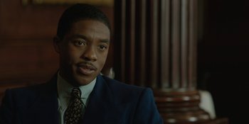 Movie still from “Marshall” (2017), directed by Reginald Hudlin – A person wearing a suit and tie; Close Up shot, Over the shoulder angle
